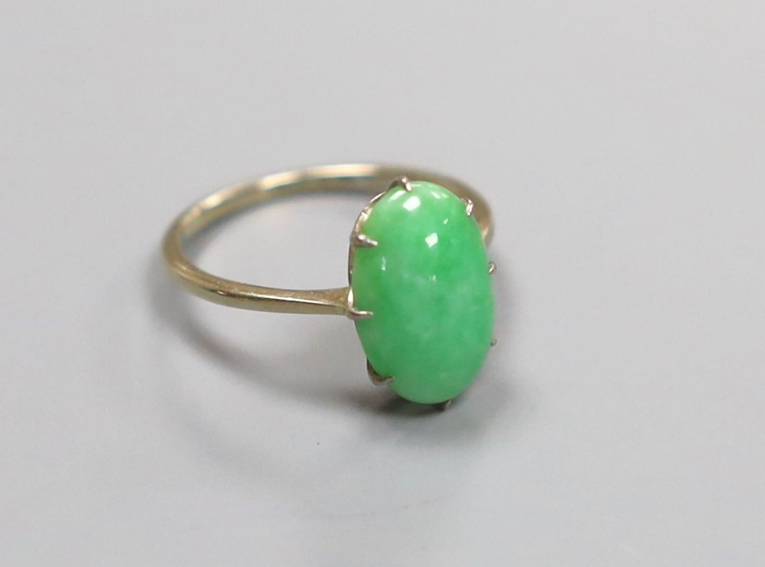 A white metal and oval cabochon jade set ring, size L, gross 2.4 grams.